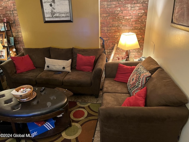 living room featuring carpet flooring and brick wall