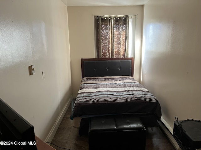 bedroom with dark tile patterned flooring