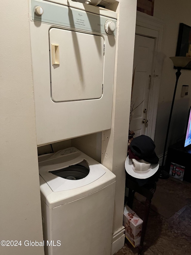 laundry area featuring stacked washer / dryer