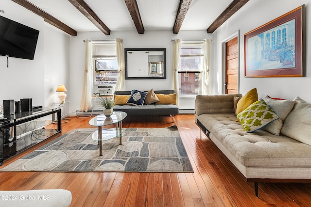 living room featuring hardwood / wood-style flooring, beamed ceiling, and baseboard heating