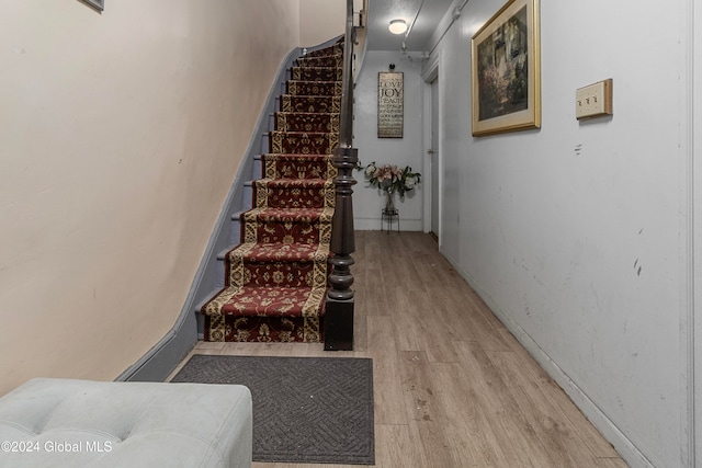 stairs with wood-type flooring