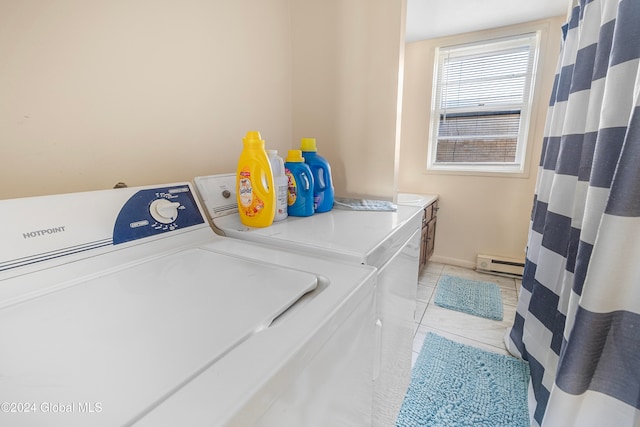 laundry room with baseboard heating, washing machine and dryer, and light tile patterned floors