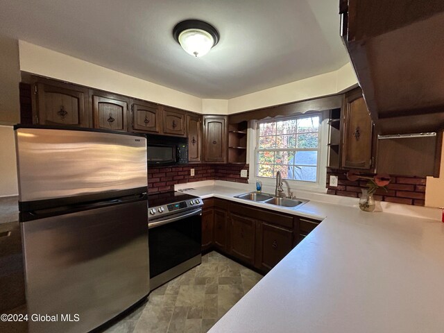 kitchen featuring dark brown cabinets, stainless steel appliances, tasteful backsplash, and sink