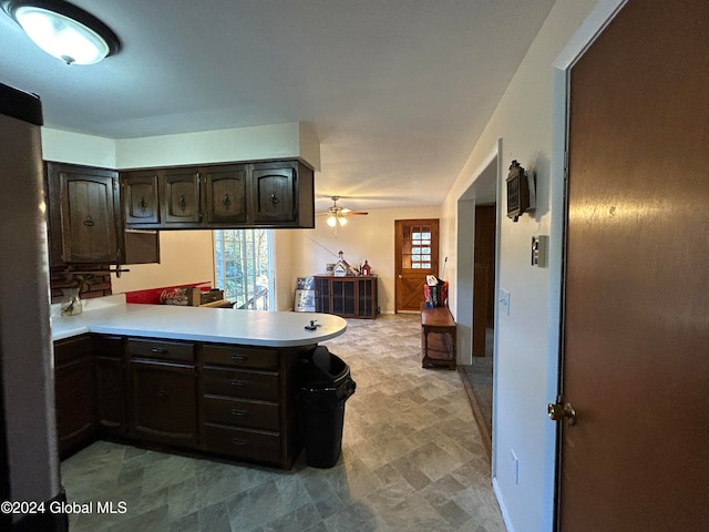 kitchen with dark brown cabinetry, kitchen peninsula, and ceiling fan