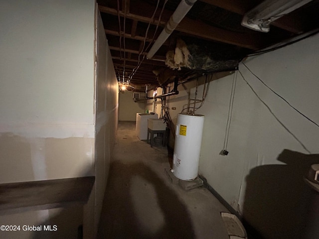 basement featuring electric water heater and washer / clothes dryer