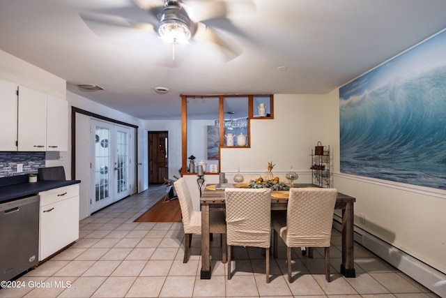 tiled dining space with ceiling fan, baseboard heating, and french doors