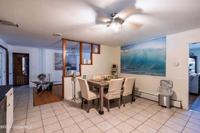 dining room with ceiling fan, light tile patterned floors, and a baseboard heating unit