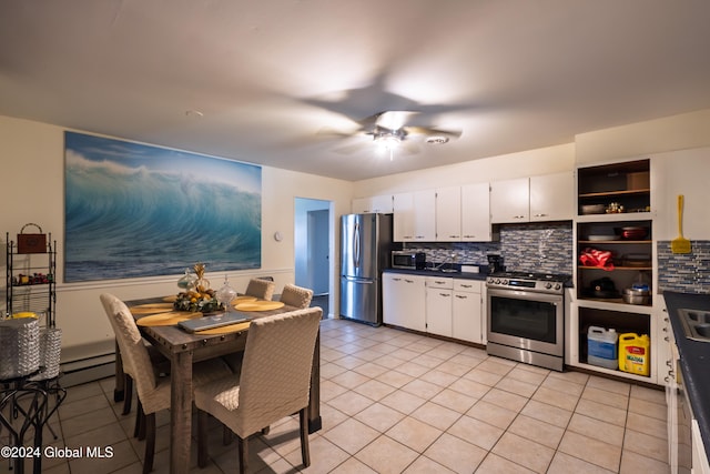 kitchen featuring backsplash, a baseboard heating unit, white cabinets, ceiling fan, and appliances with stainless steel finishes