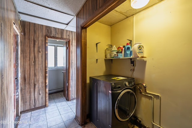 washroom with washer / clothes dryer, wood walls, light tile patterned floors, and a baseboard heating unit