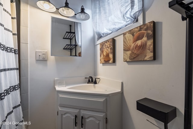 bathroom with curtained shower and vanity