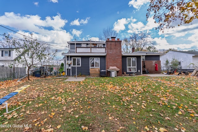 back of property with a patio area and a yard