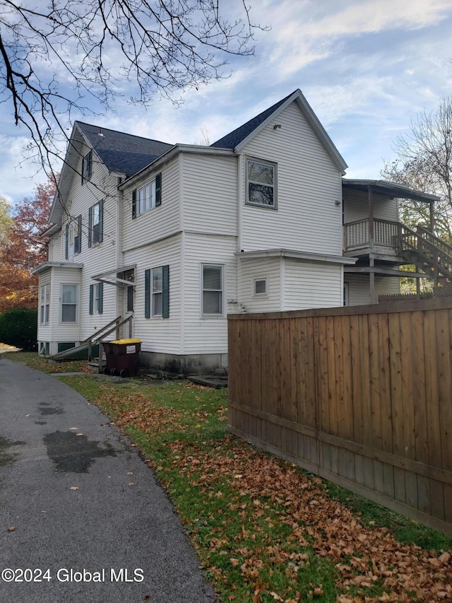 view of side of home with a balcony