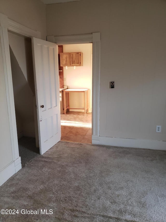 unfurnished room with light carpet