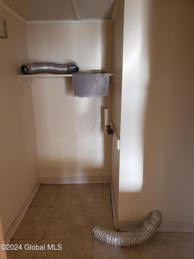 room details featuring ornamental molding and tile patterned floors