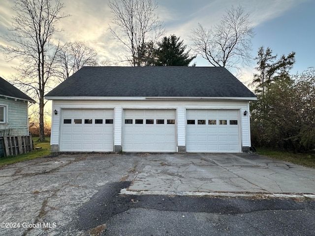 view of garage at dusk