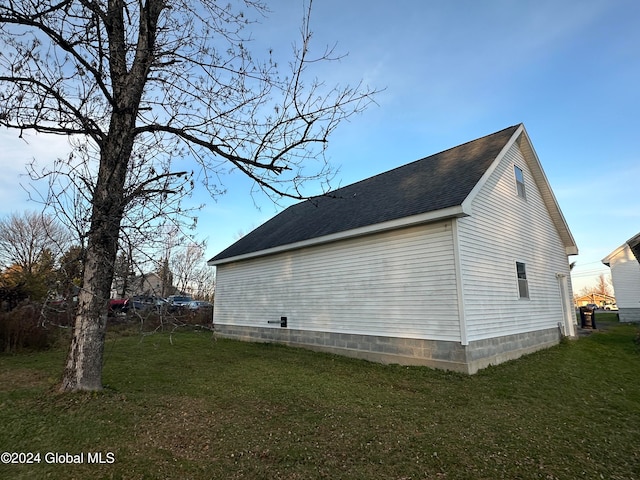 view of property exterior featuring a lawn