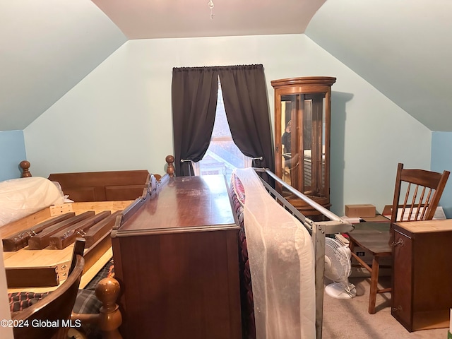 bedroom featuring vaulted ceiling and light colored carpet