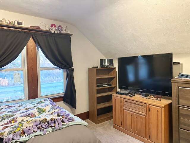 carpeted bedroom with lofted ceiling