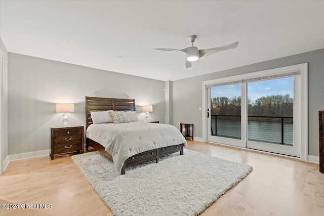 bedroom with access to exterior, light hardwood / wood-style flooring, and ceiling fan