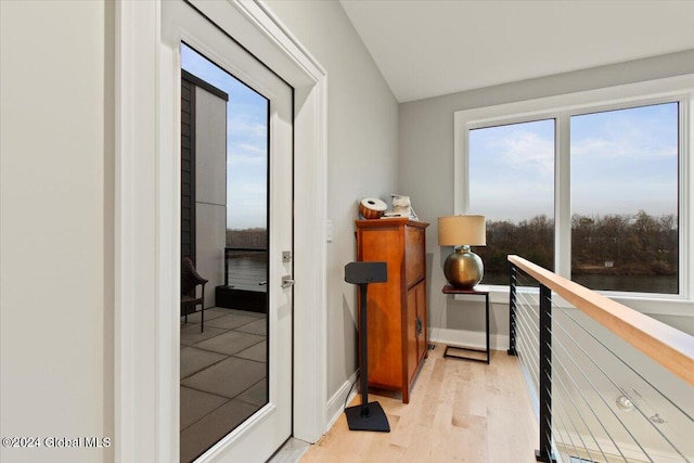 hall featuring light hardwood / wood-style flooring and a water view