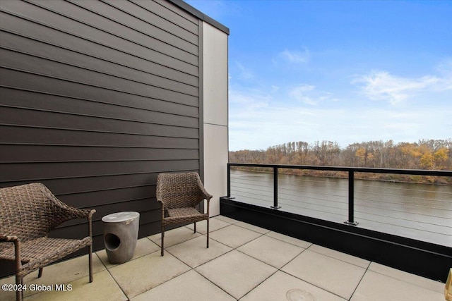 view of patio / terrace with a water view and a balcony