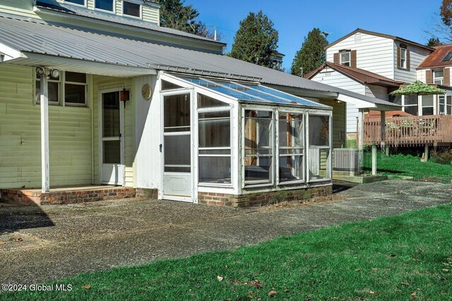 rear view of property with a wooden deck