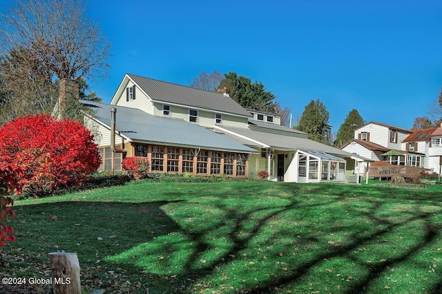 rear view of house with a lawn