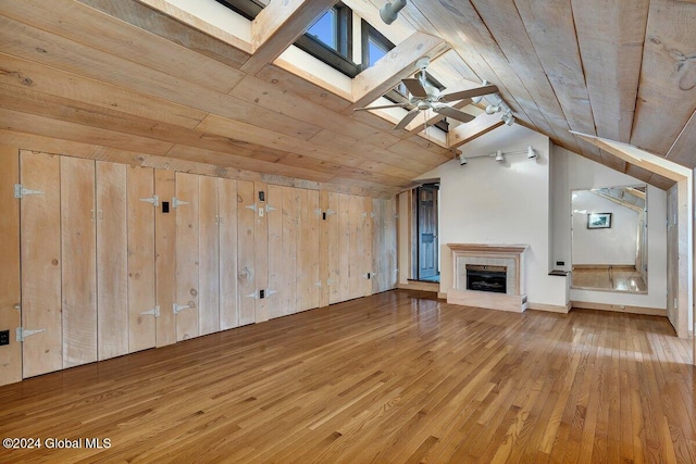 unfurnished living room with wood ceiling, vaulted ceiling with skylight, and hardwood / wood-style floors