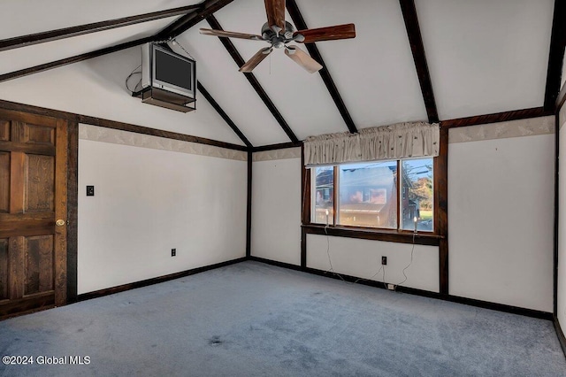 spare room featuring lofted ceiling with beams, light colored carpet, and ceiling fan