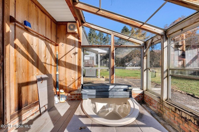 unfurnished sunroom with vaulted ceiling