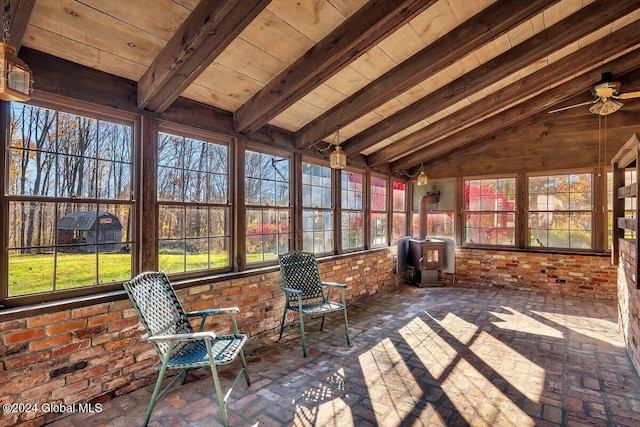 unfurnished sunroom featuring vaulted ceiling with beams, wood ceiling, a wood stove, and ceiling fan