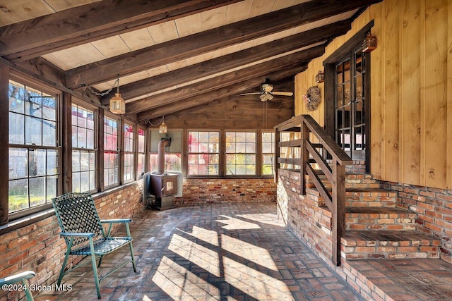 unfurnished sunroom featuring lofted ceiling with beams, ceiling fan, and wooden ceiling