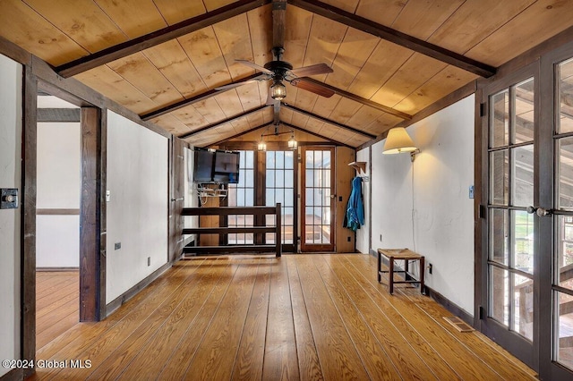 empty room featuring lofted ceiling with beams, wood ceiling, light hardwood / wood-style flooring, and ceiling fan