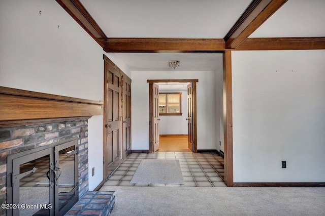 hallway featuring beamed ceiling and light tile patterned floors