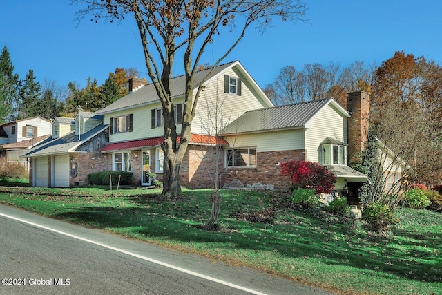 view of front property featuring a front lawn and a garage