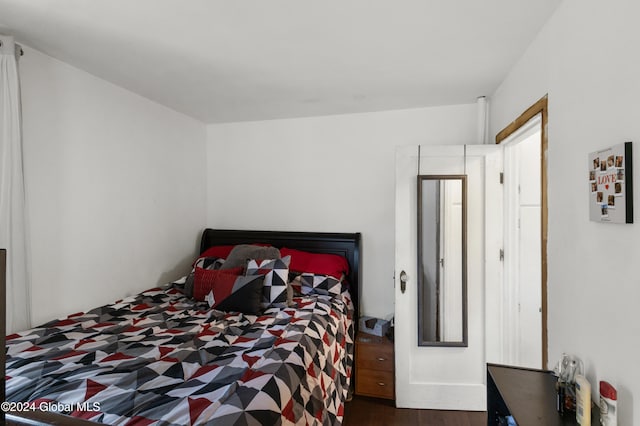 bedroom with dark wood-type flooring