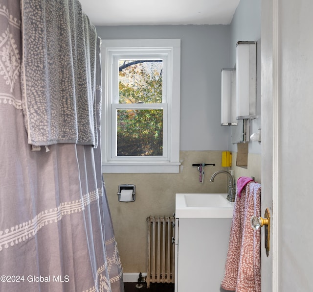 bathroom with vanity and radiator heating unit