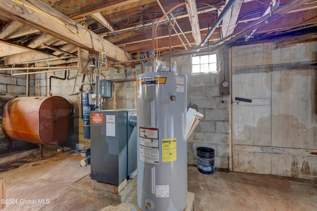 utility room with gas water heater and electric water heater