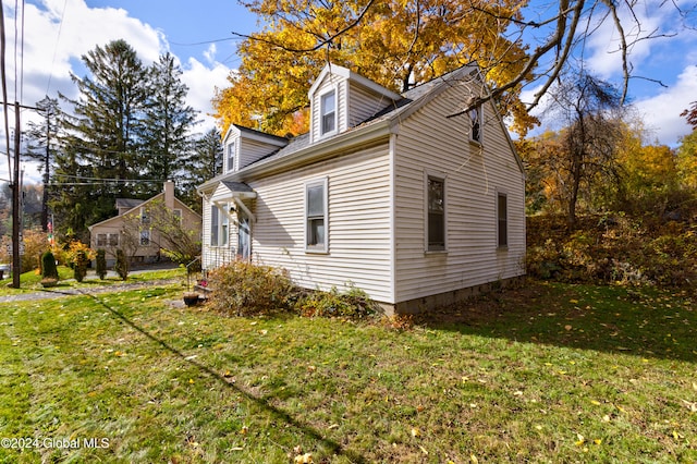 view of side of home featuring a lawn