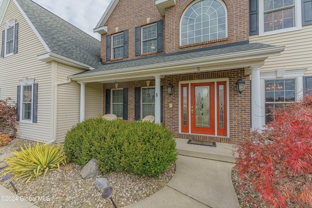 5 Teasdale Ct, Colonie, NY 12189 - doorway to property with roof with shingles, covered porch, and brick siding