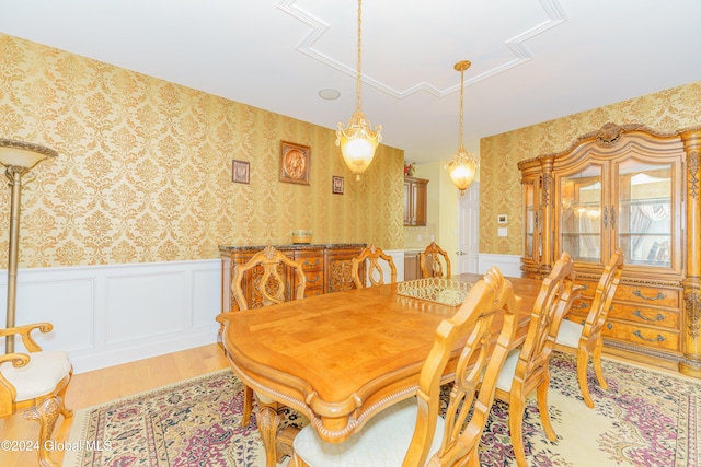 5 Teasdale Ct, Colonie, NY 12189 - dining space featuring attic access, wainscoting, a decorative wall, wallpapered walls, and light wood-style flooring