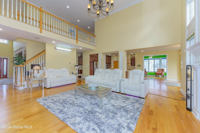 5 Teasdale Ct, Colonie, NY 12189 - living room featuring stairway, baseboards, a chandelier, a high ceiling, and light wood-style flooring