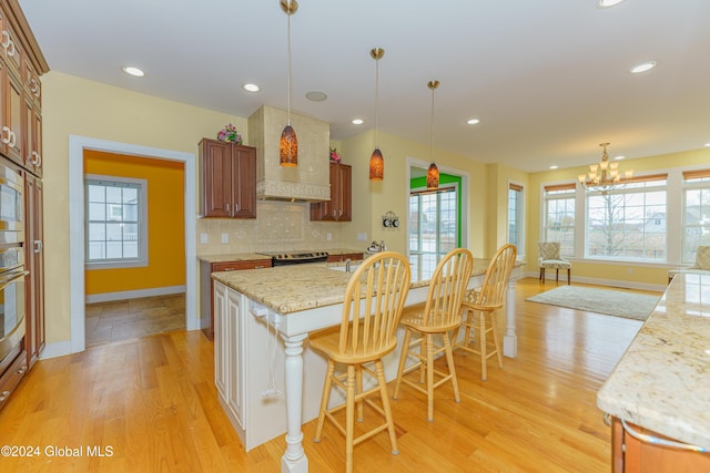 5 Teasdale Ct, Colonie, NY 12189 - kitchen with baseboards, an inviting chandelier, a healthy amount of sunlight, and light wood-type flooring