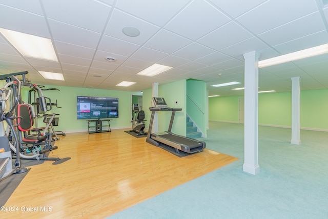 workout area featuring hardwood / wood-style flooring and a paneled ceiling