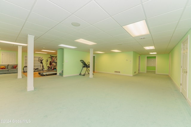 basement with a drop ceiling and light carpet