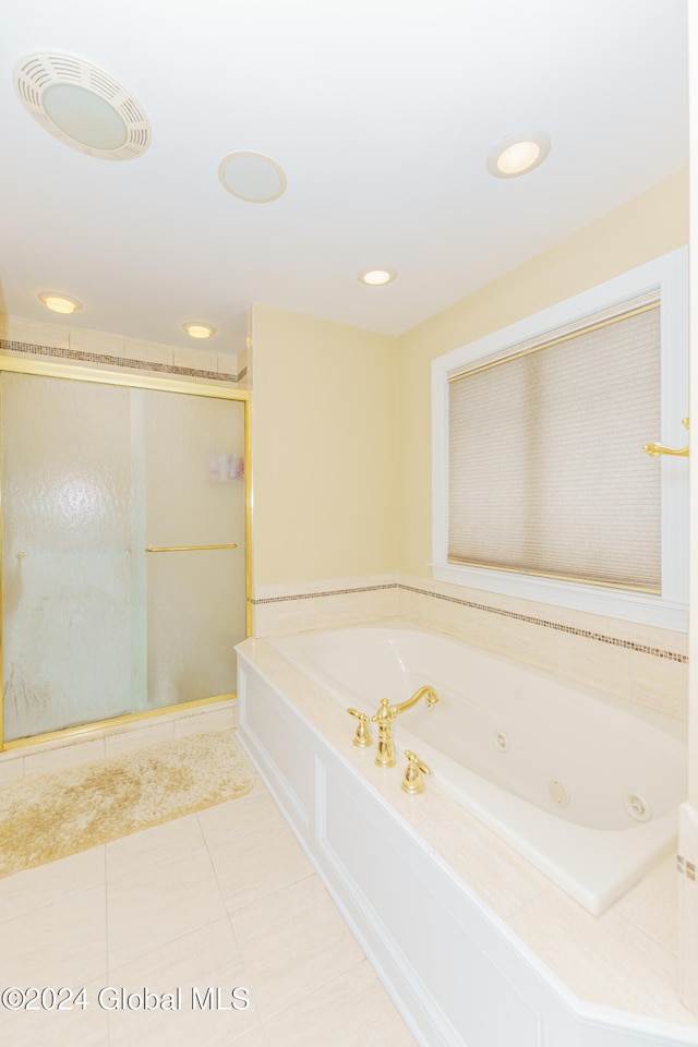 bathroom featuring plus walk in shower and tile patterned flooring