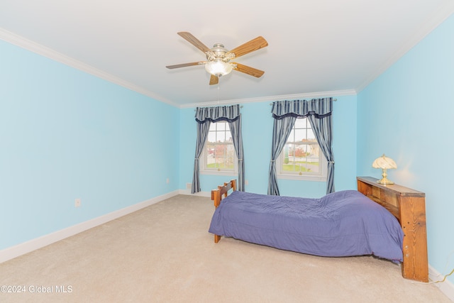 carpeted bedroom featuring ceiling fan and crown molding