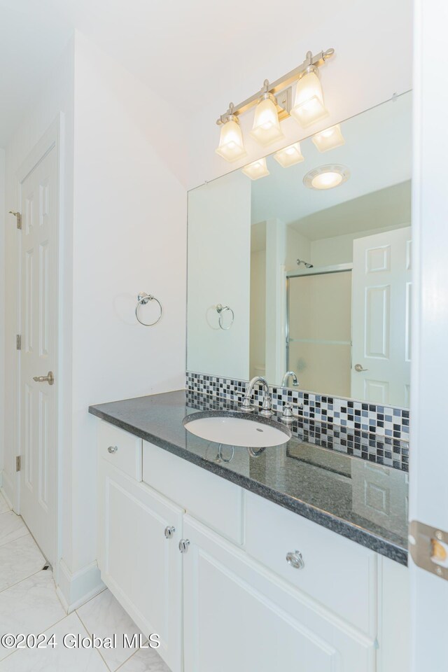 5 Teasdale Ct, Colonie, NY 12189 - bathroom with vanity, baseboards, a shower with shower door, and tasteful backsplash