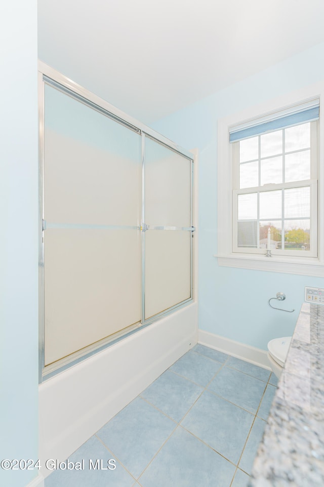 full bathroom with vanity, shower / bath combination with glass door, toilet, and tile patterned floors