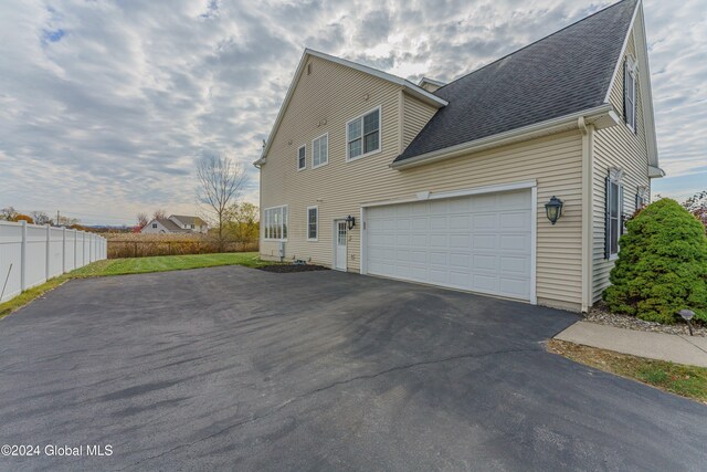 5 Teasdale Ct, Colonie, NY 12189 - view of property exterior with a garage, fence, roof with shingles, and aphalt driveway